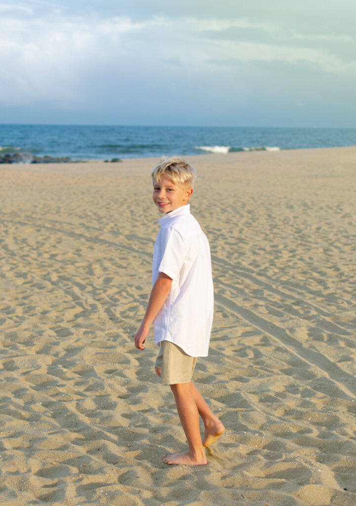 Kids Portrait 1 Portrait of the boy walking towards ocean in white shirt at Jersey beach.