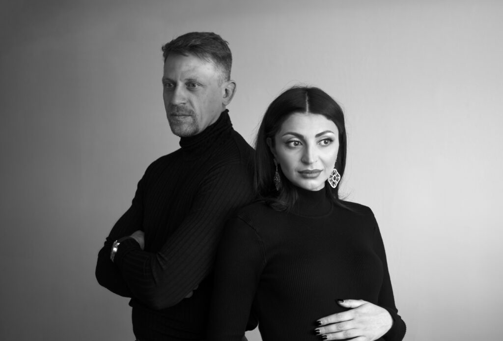 Couple Portrait 1 portrait of mom and dad to be dressed in black smiling together in a NJ photo studio.