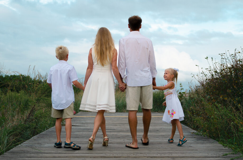 Family photo back Colorful family photo with parents and children walking together at the Jersey beach.