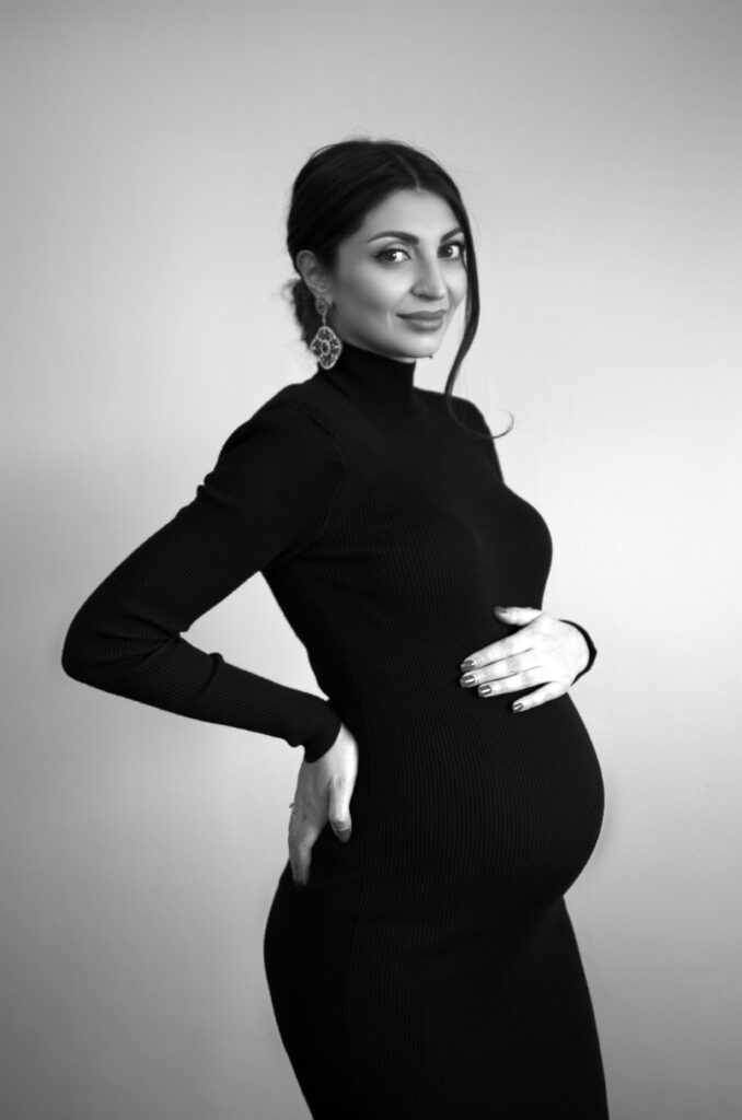 Mother to be 1 Tender NJ studio portrait of an expectant mother gently cradling her baby bump