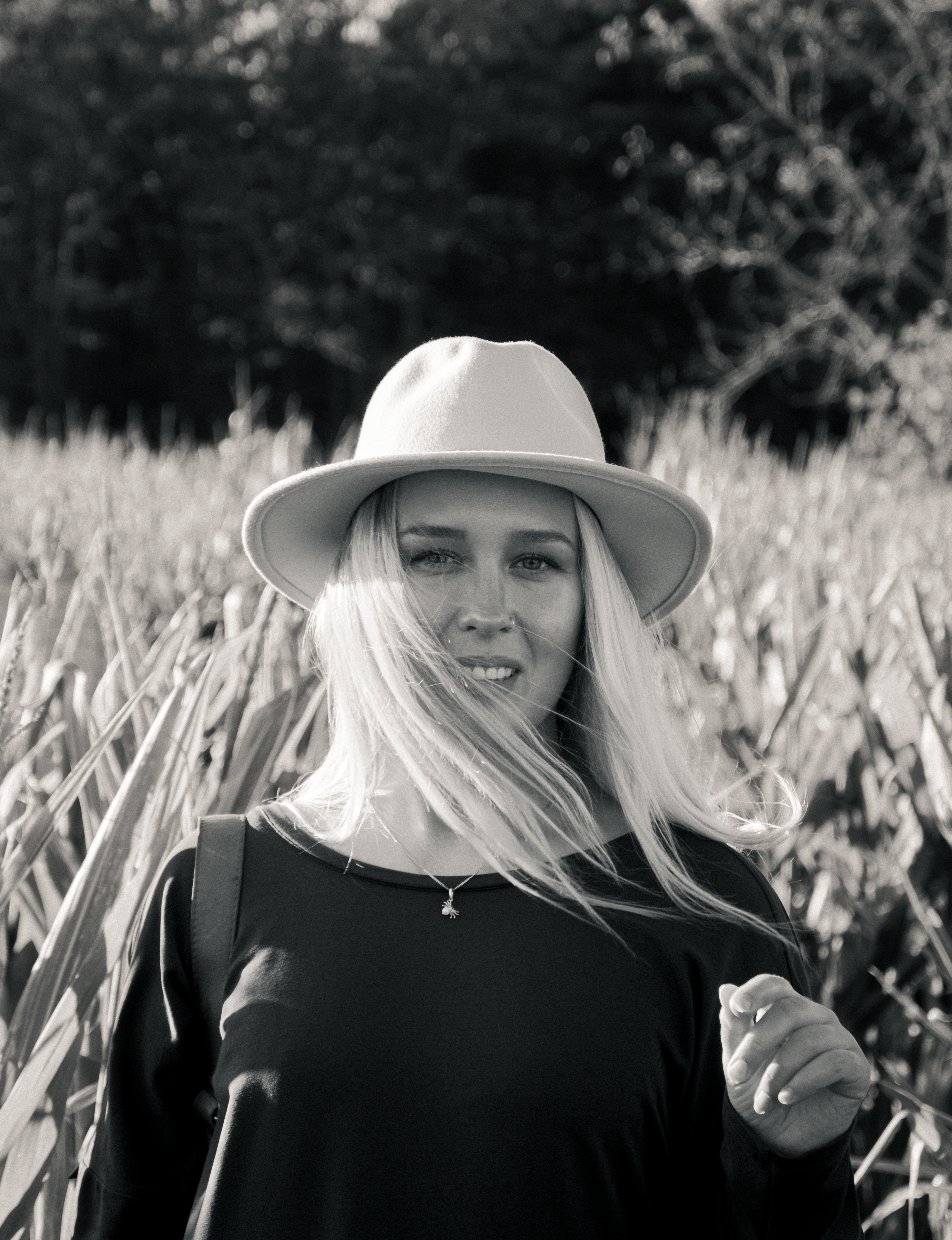 Natural light portrait of a woman smiling, outdoors on the Jersey corn field.