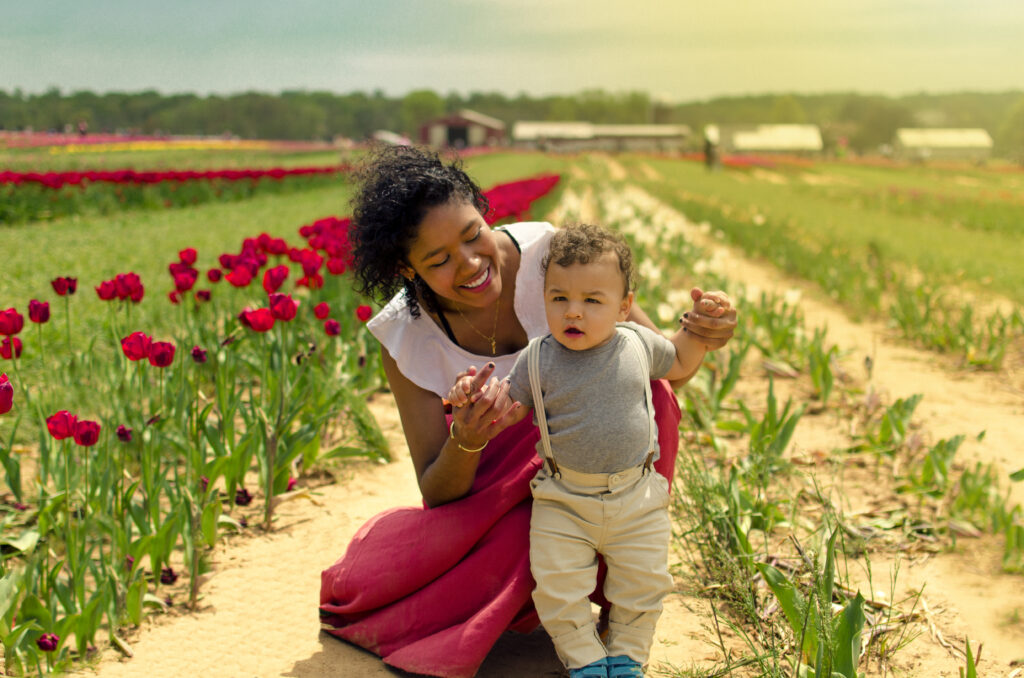 Tulip Farm 1 Family portrait of mother and toddler playing among blooming tulips on farm in NJ.