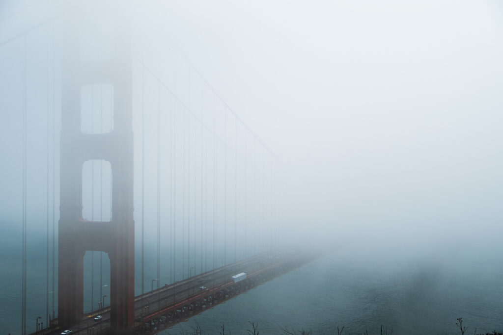 golden gate fog 2 Moody view of the Golden Gate Bridge shrouded in thick fog, with the roadway barely visible